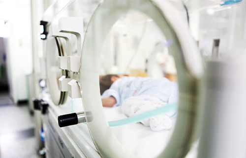 newborn in nicu bed