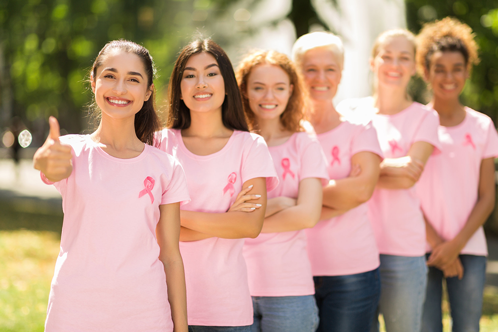 Women in pink shirts and wearing pink ribbons