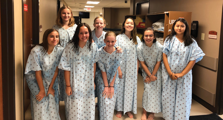 High school girls in hospital gowns