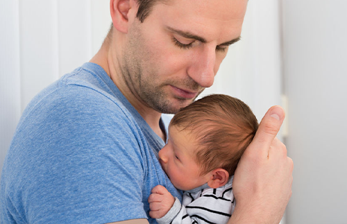 father holding newborn