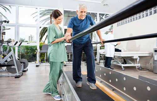 nurse helping man on treadmill