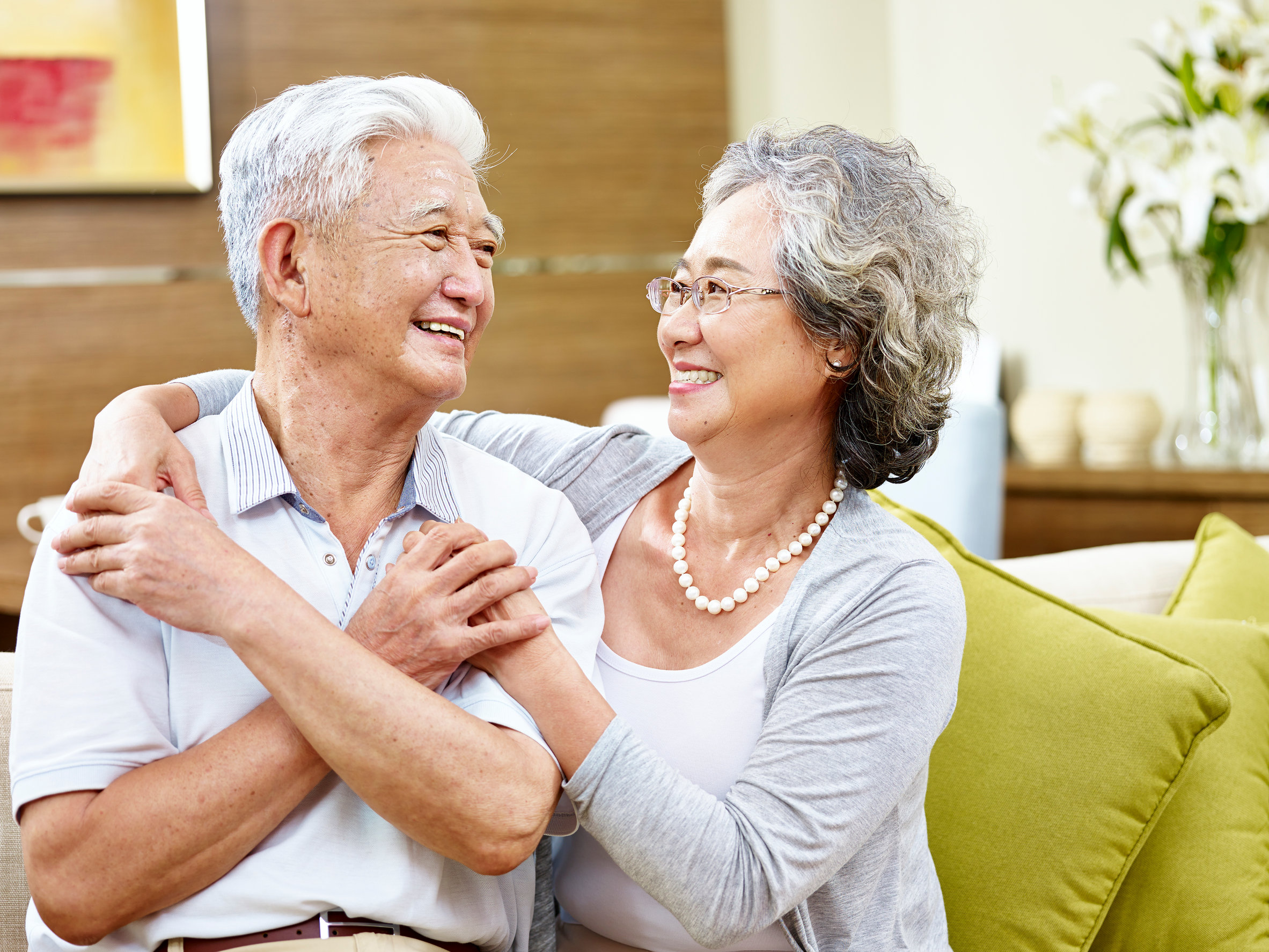 loving asian couple looking at each other smiling with appreciation