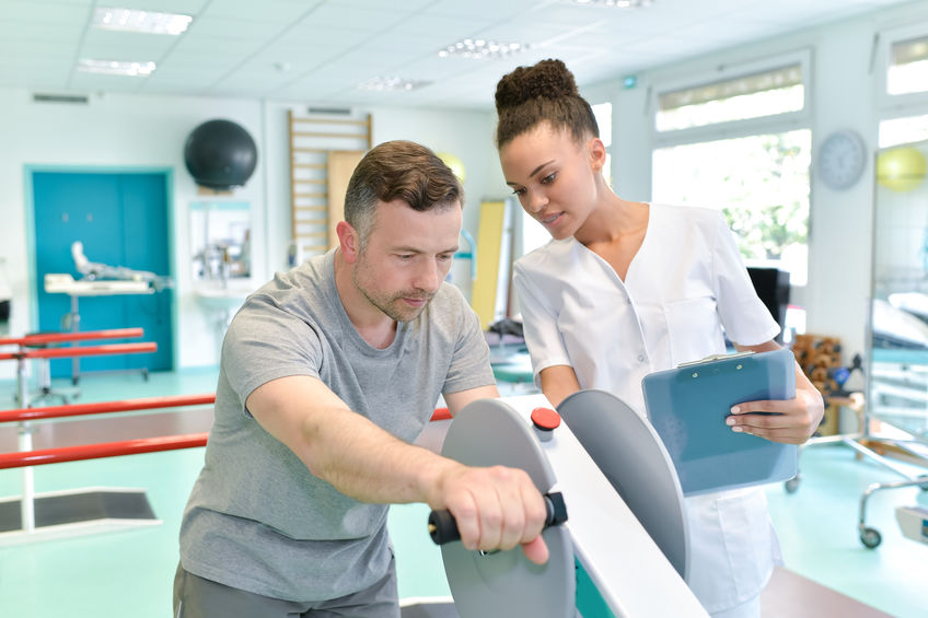 doctor with patient in rehab facility