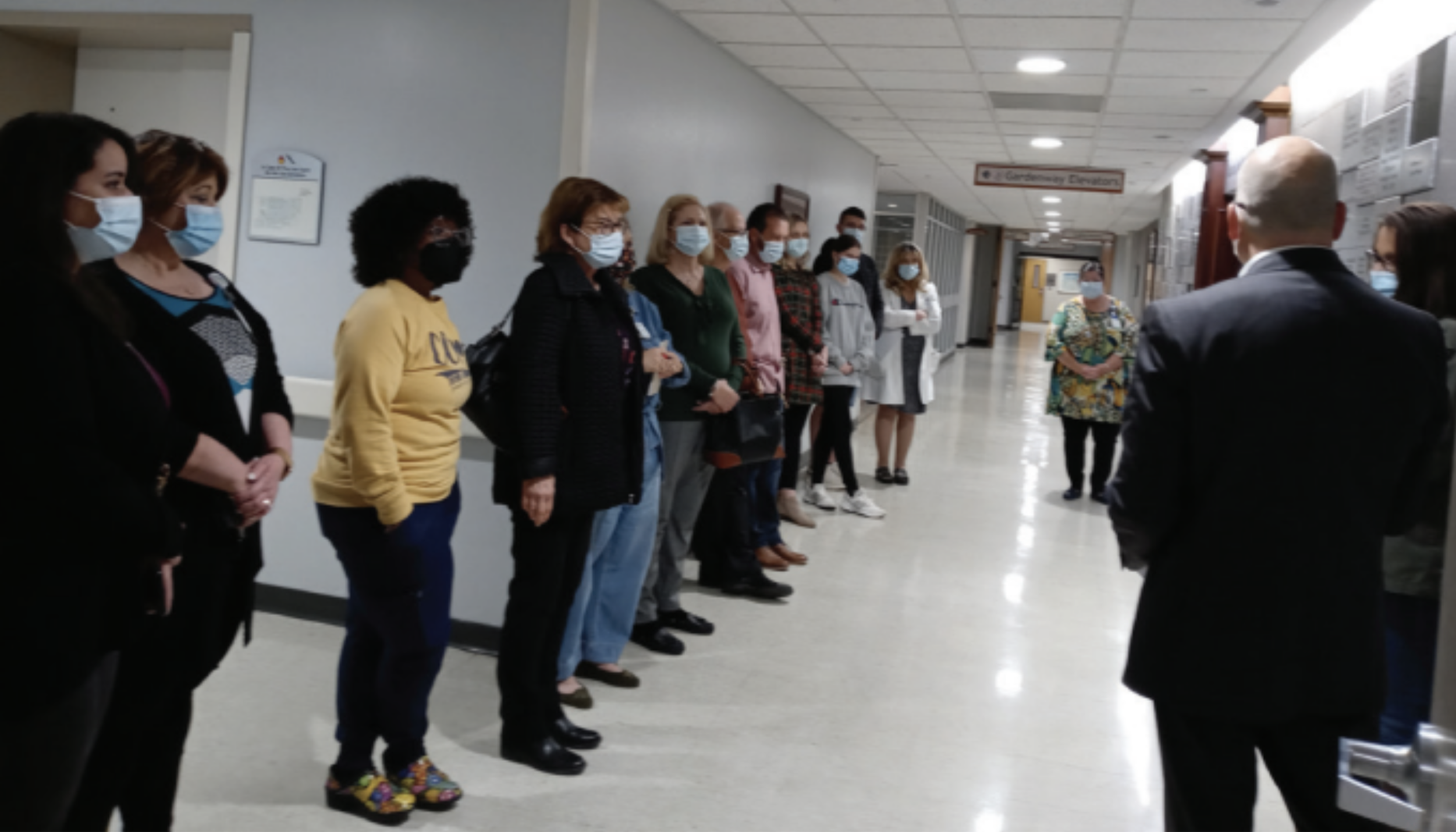 People Stand in Hallway to see chapel tile reveal