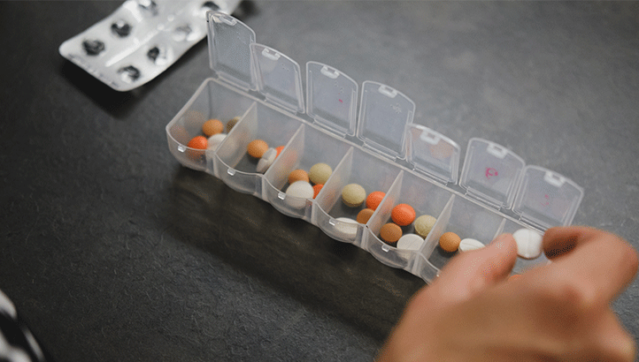 medication in a daily scheduler container - prevent drug overdose 