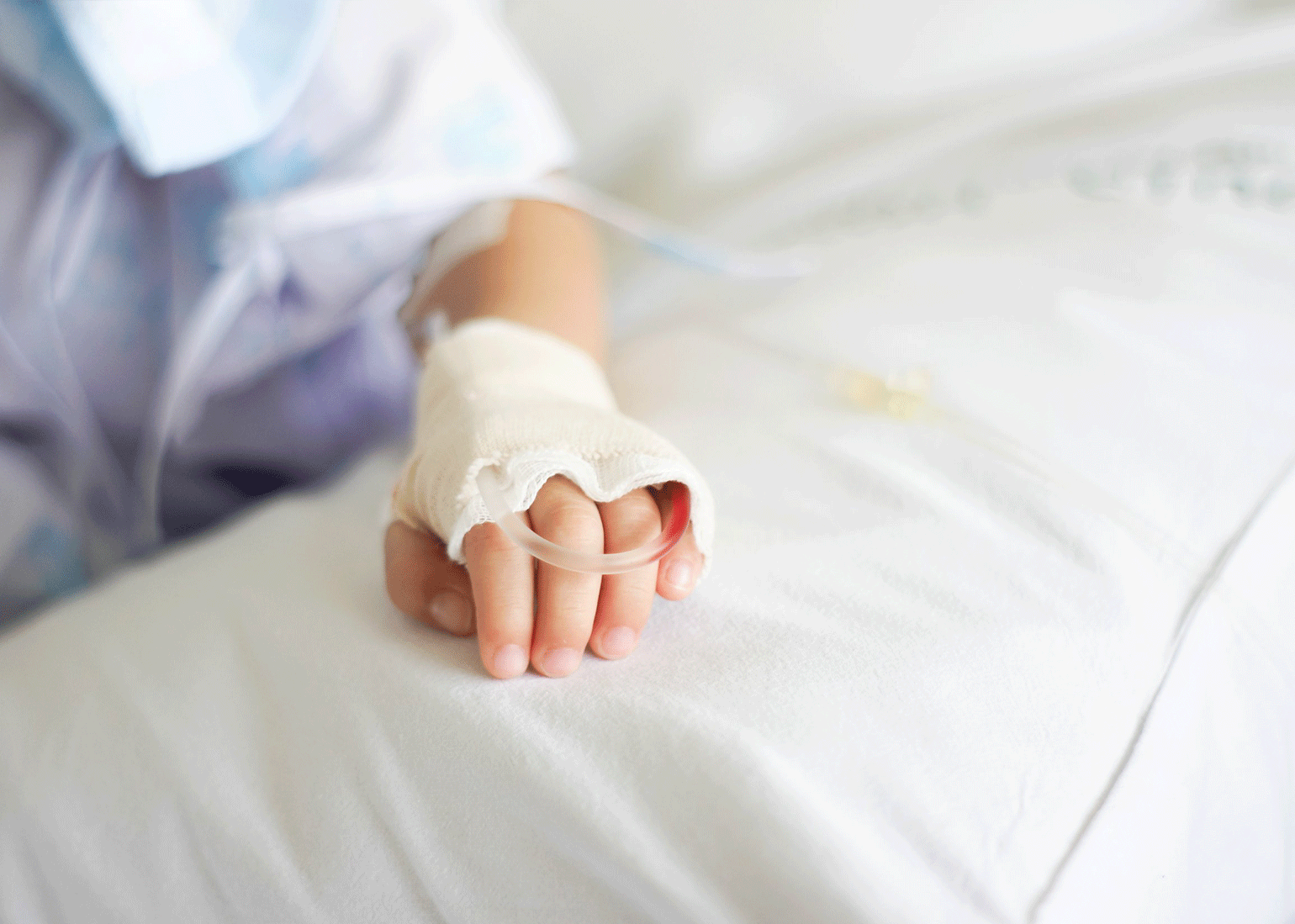 Child laying on hospital bed