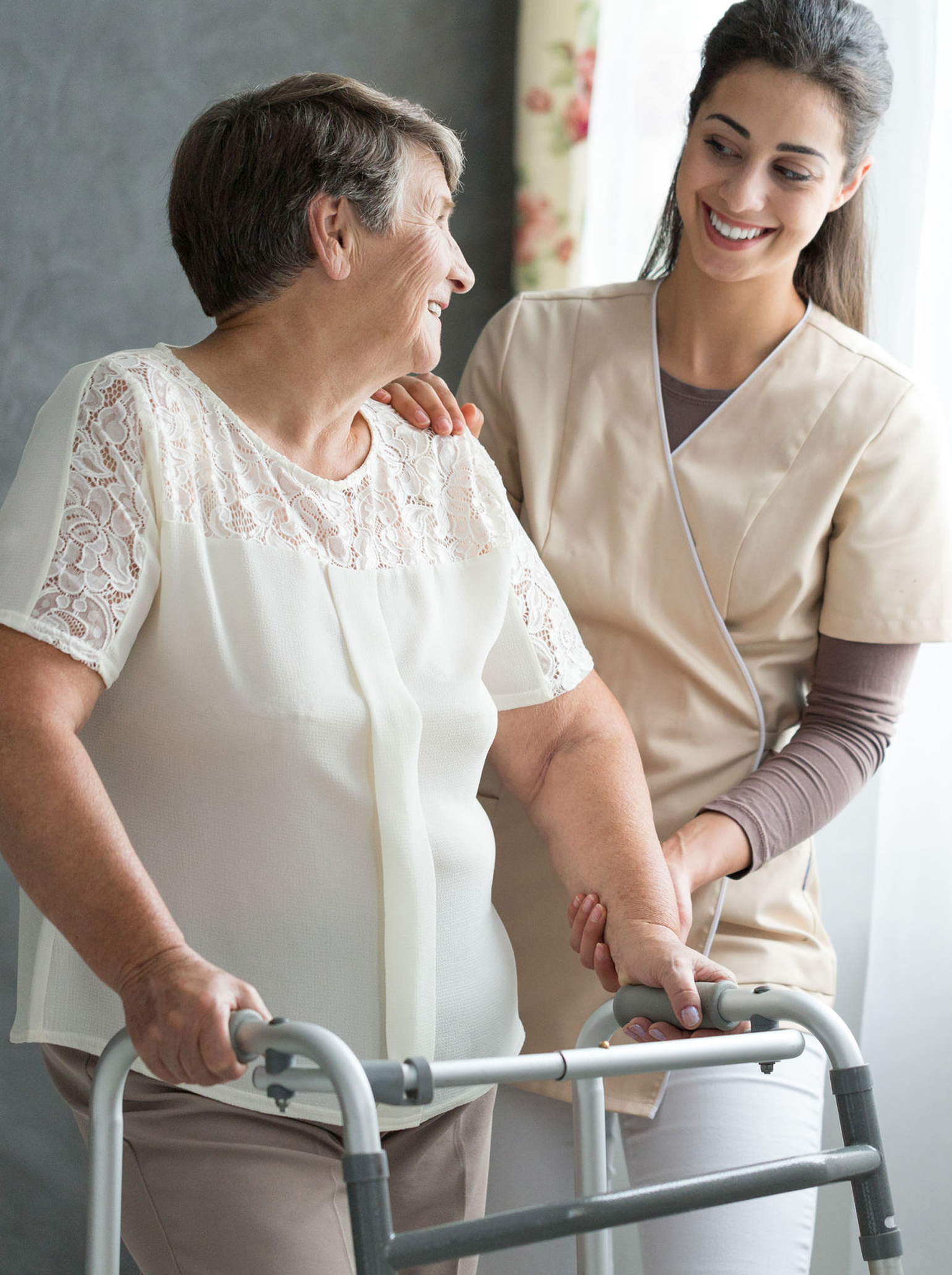 nurse helping elderly woman